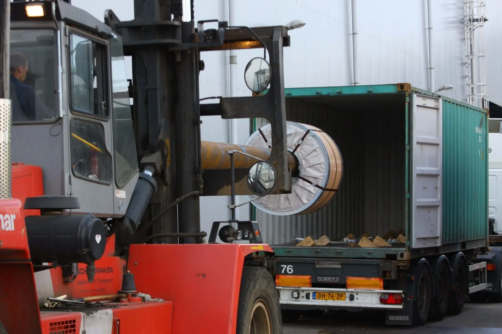 Steel coil being stuffed into a container at the terminal